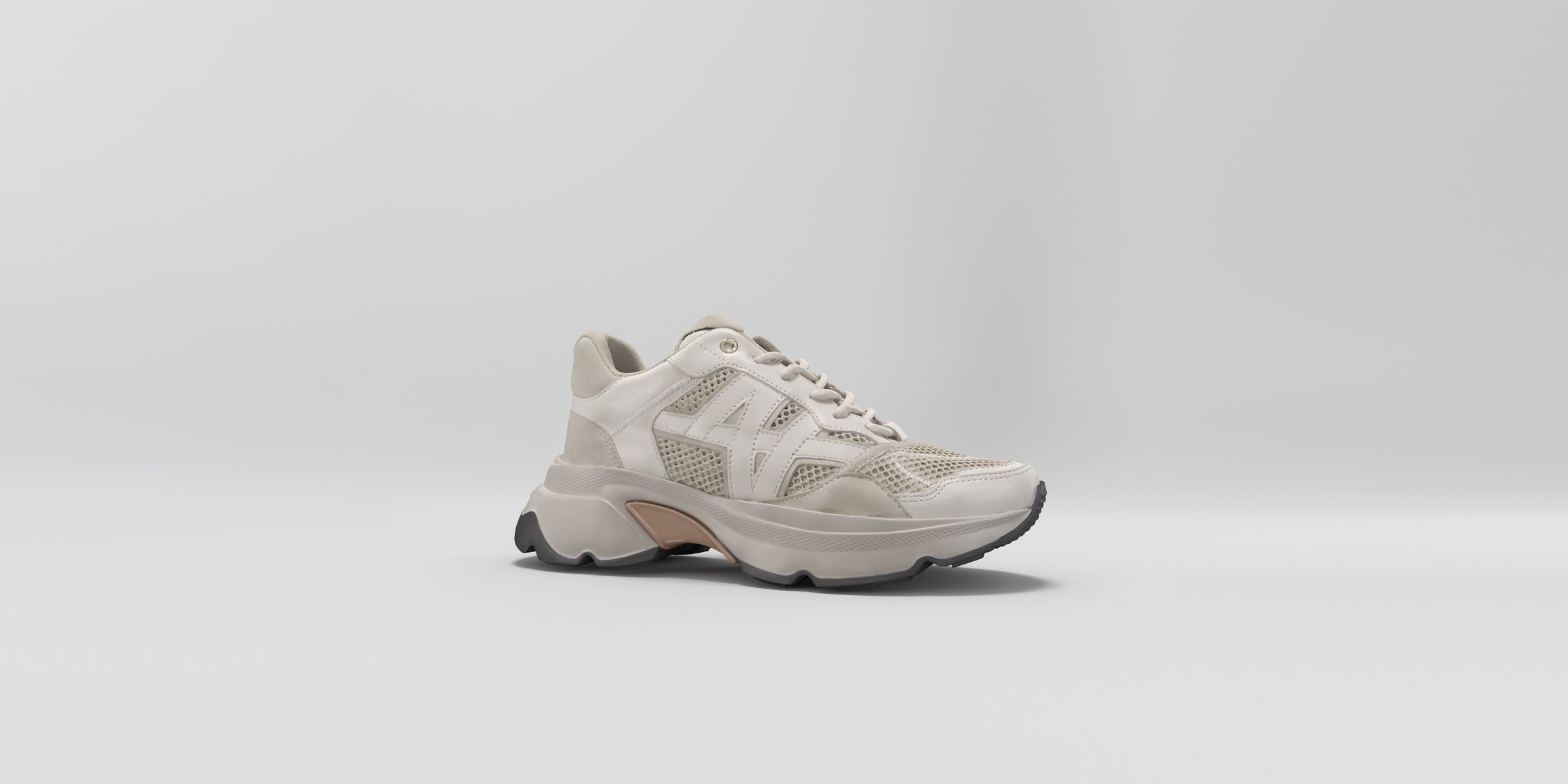 Lichte Nubikk-sneaker schuin van voren op een grijze achtergrond, een beeld uit de 360-gradenweergave van de A/B-test